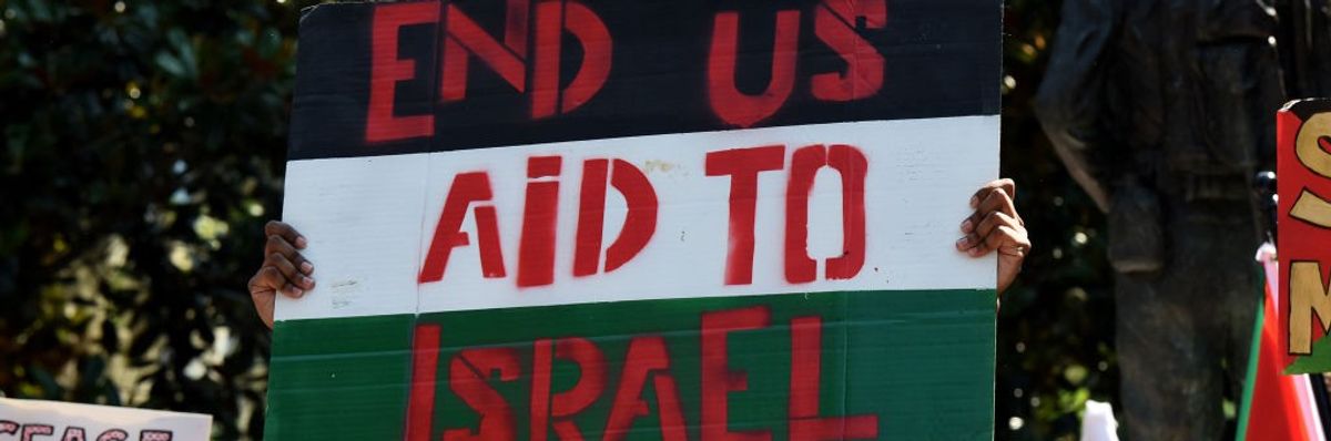 Pro-Palestinian demonstrators chant slogans before marching with placards and flags