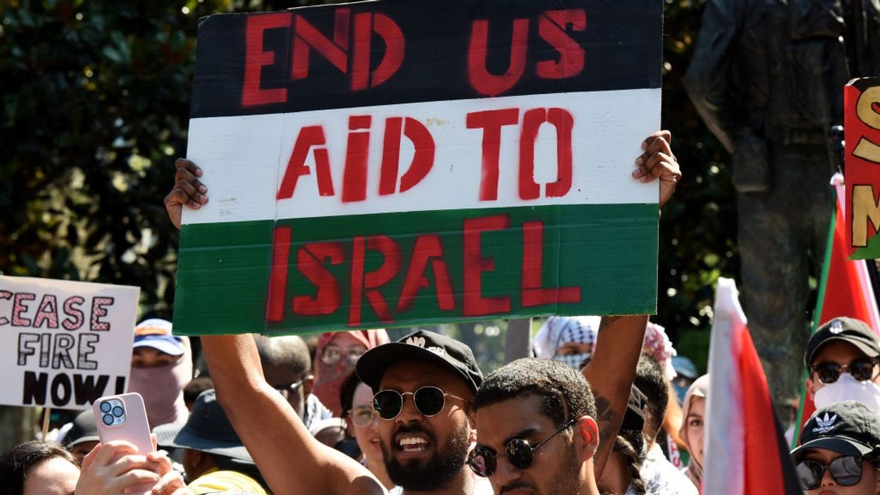 Pro-Palestinian demonstrators chant slogans before marching with placards and flags