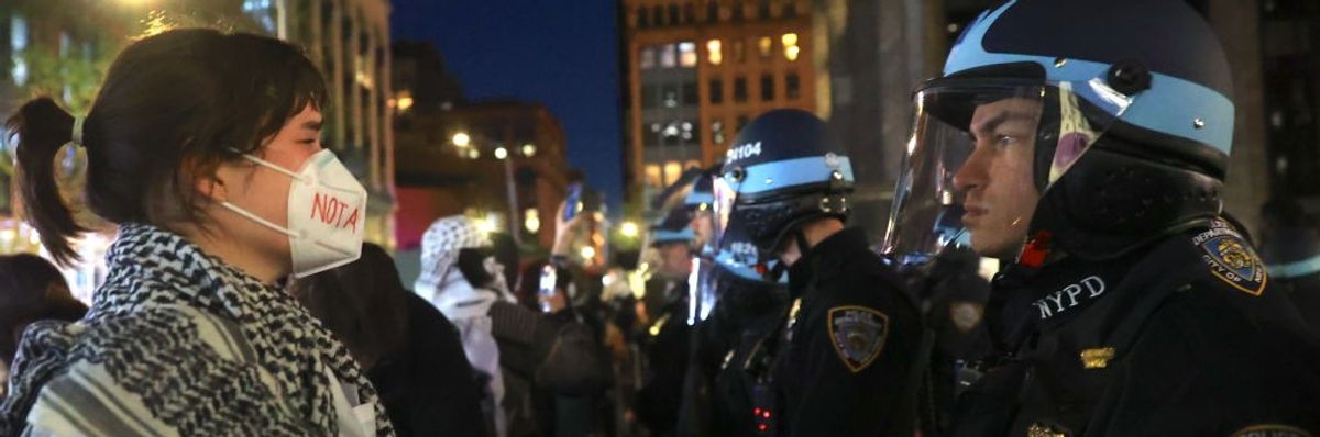 Pro-Palestinian protester faces NYPD officers near New York University