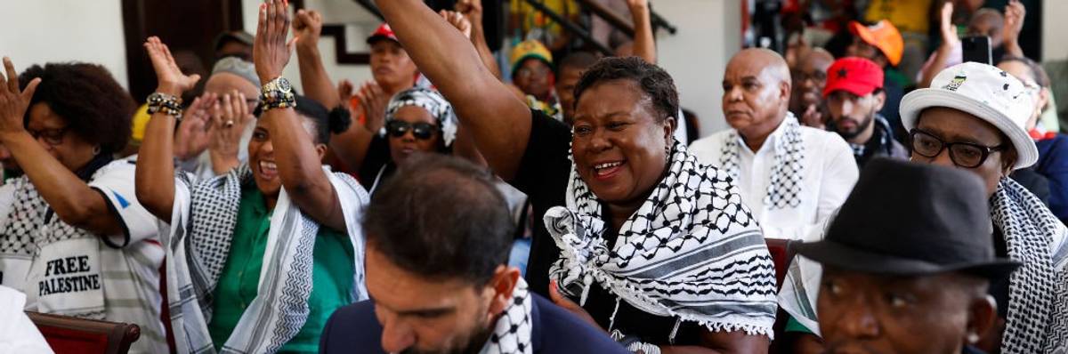 Pro-Palestinian supporters react as they watch the International Court of Justice