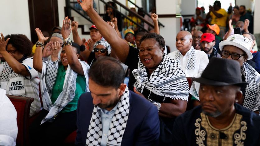 Pro-Palestinian supporters react as they watch the International Court of Justice