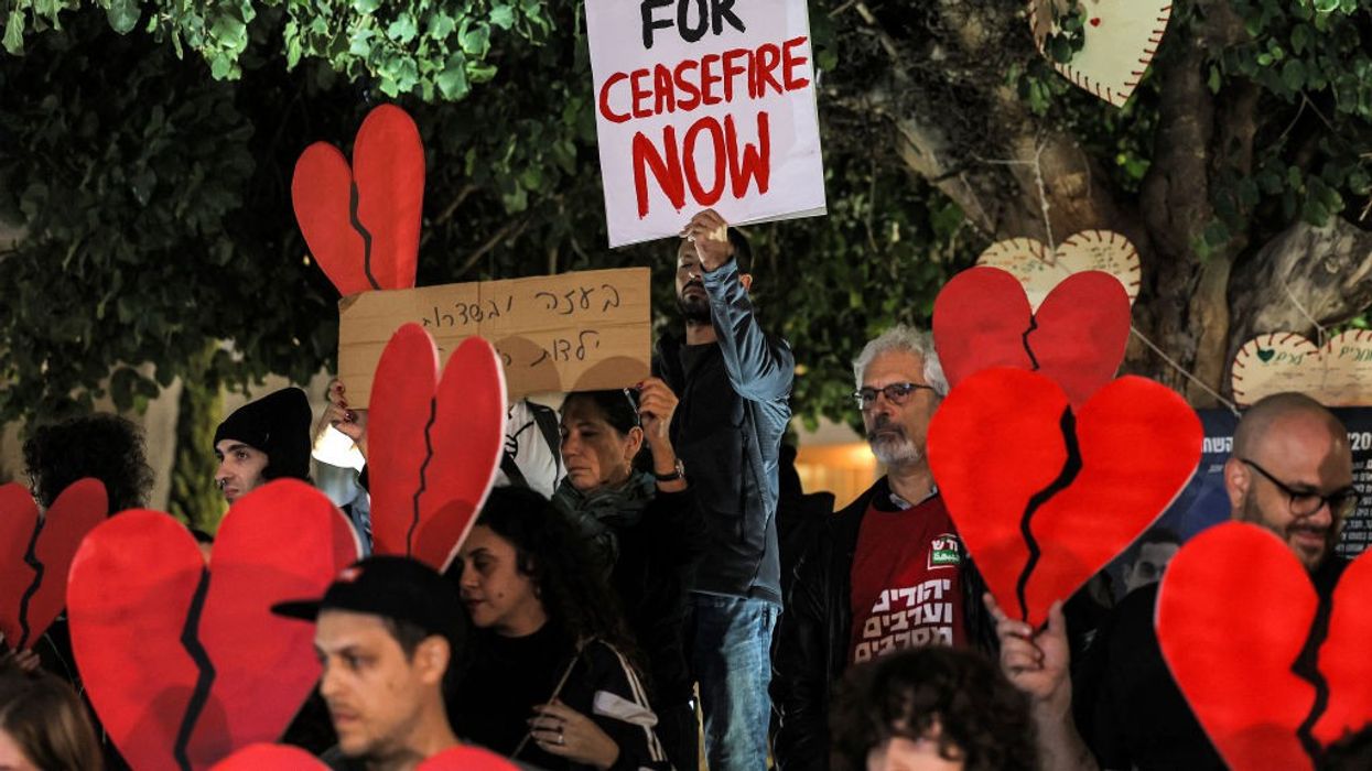 Pro-peace demonstrators gather in Tel Aviv ather with broken heart signs and placard that says "Isreali for Ceasefire Now"