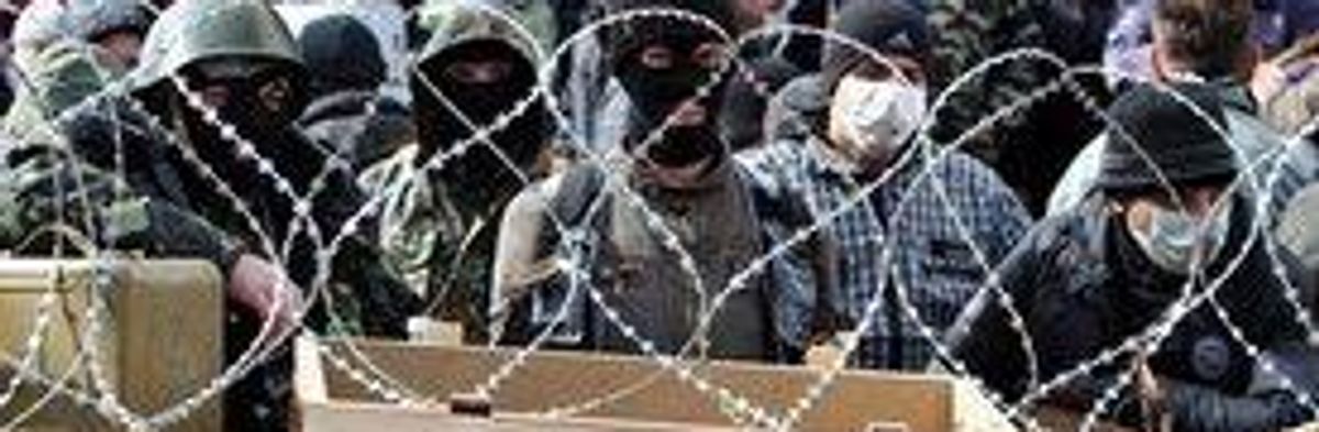 Pro-Russian activists guard a barricade outside the security service building in Donetsk