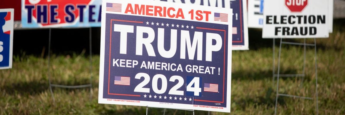 Pro-Trump election signs in grass.