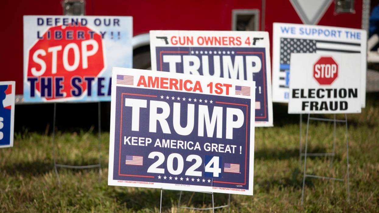 Pro-Trump election signs in grass.