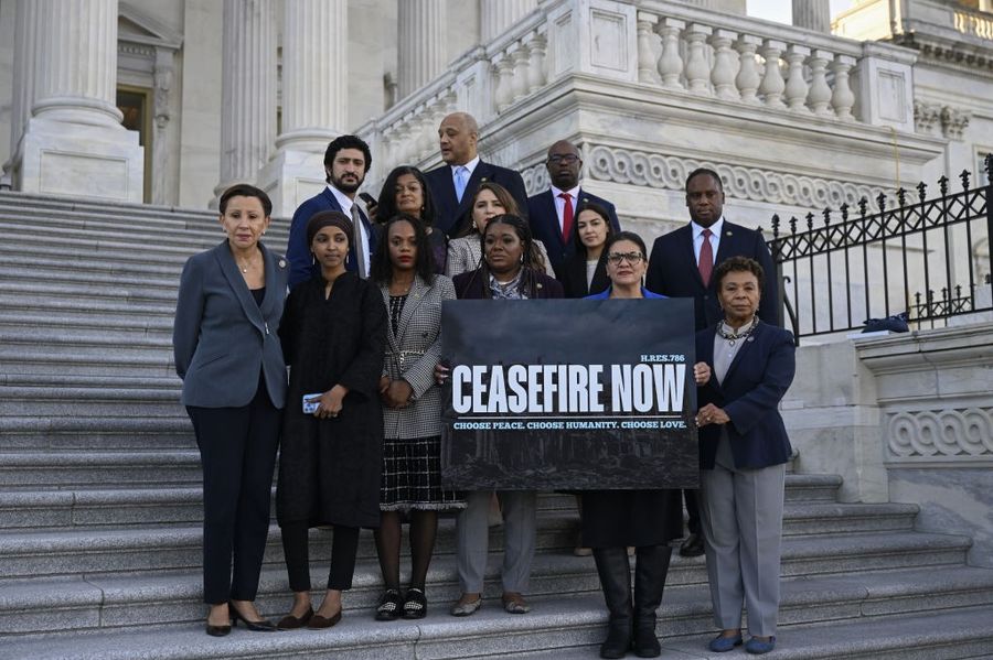 Progressive members of Congress hold a banner demanding a cease-fire