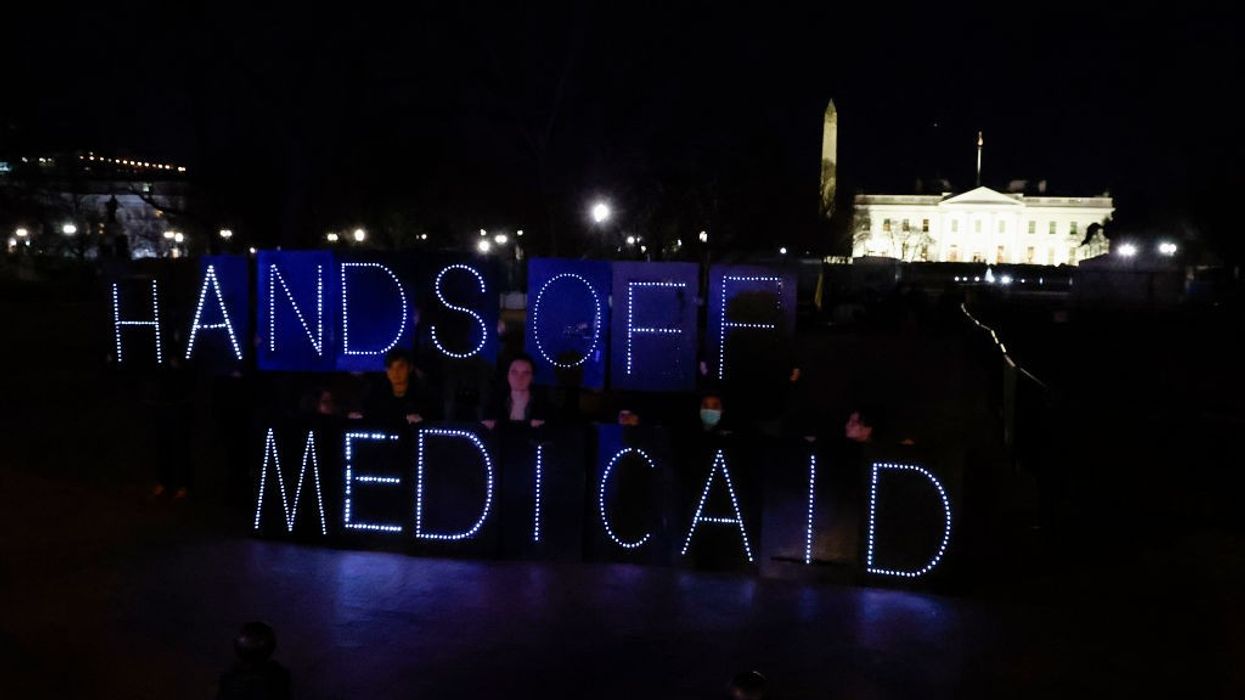 Protect Our Care Supporters Display "Hands Off Medicaid" Message In Front Of The White House Ahead Of President Trump's Address To Congress