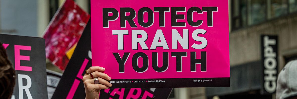 "Protect trans youth" sign