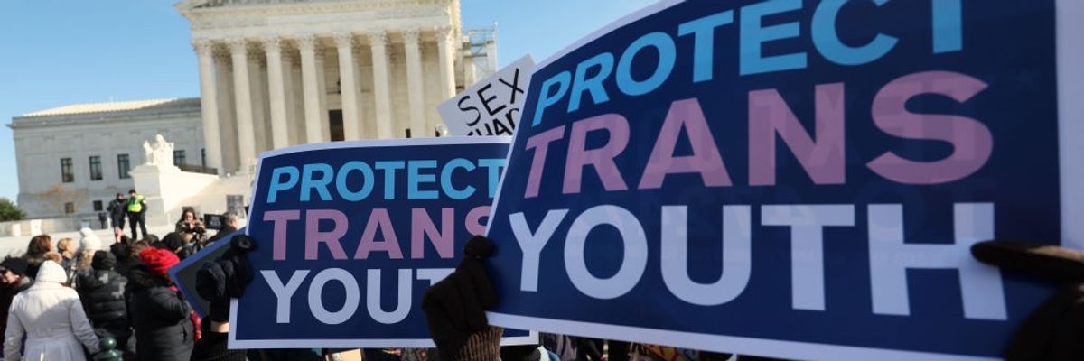 "Protect Trans Youth," signs say