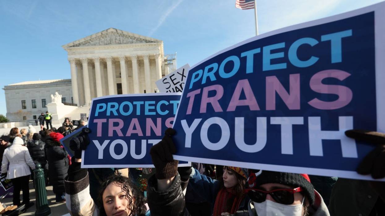 "Protect Trans Youth," signs say