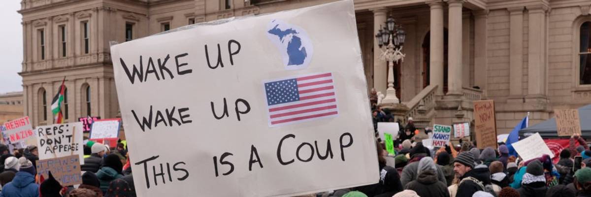 Protest against Trump with sign saying, "Wake up, wake up, this is a coup."