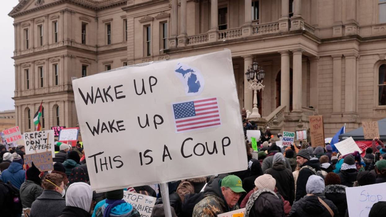 Protest against Trump with sign saying, "Wake up, wake up, this is a coup."