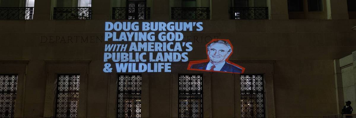 Protest messages are projected at the US Department of the Interior
