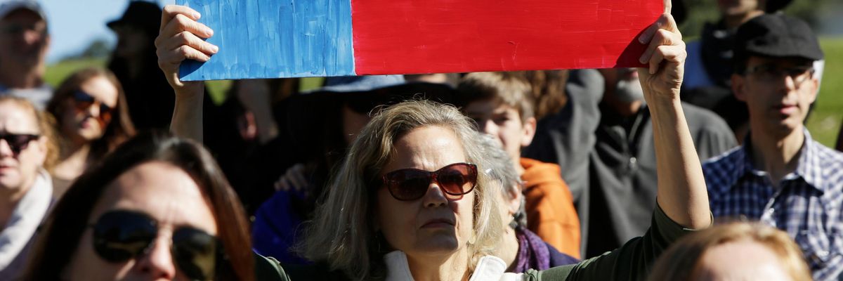 Protest sign reading, "Bigotry and cowardice are not Texas values"
