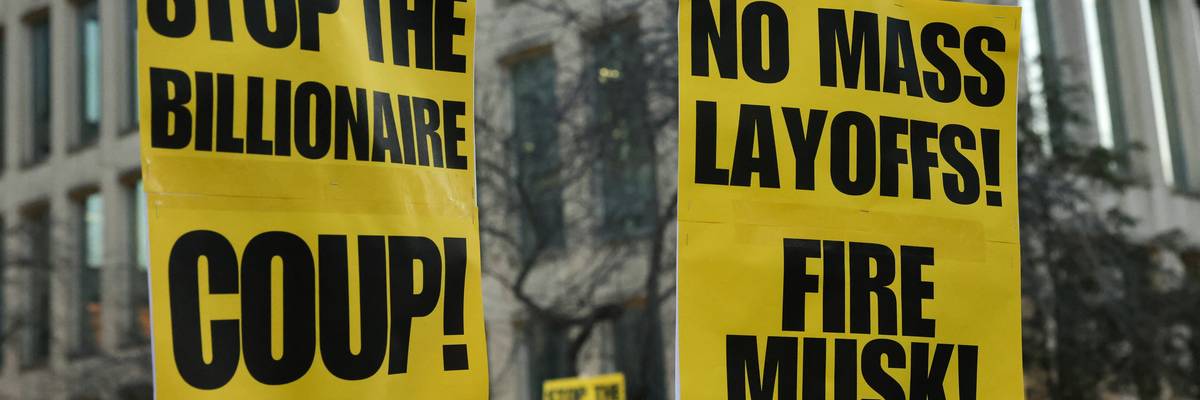 Protest signs against Musk's layoffs.