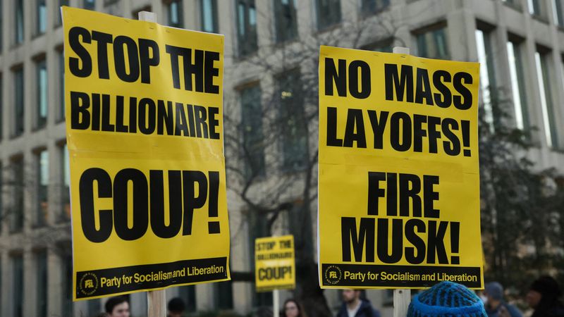 Protest signs against Musk's layoffs.