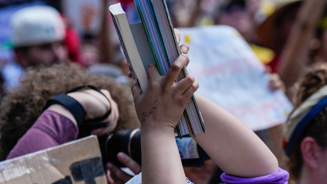 Protester holds books