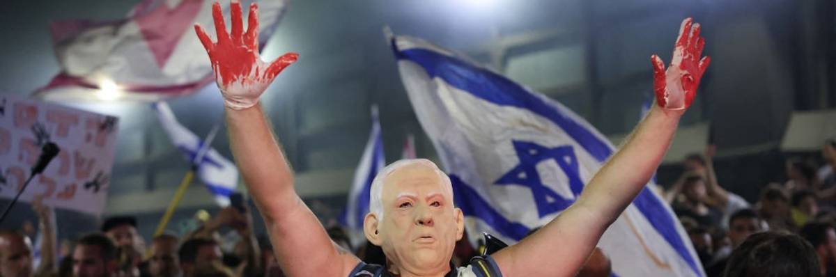 Protester wearing Netanyahu mask with blood-soaked hands