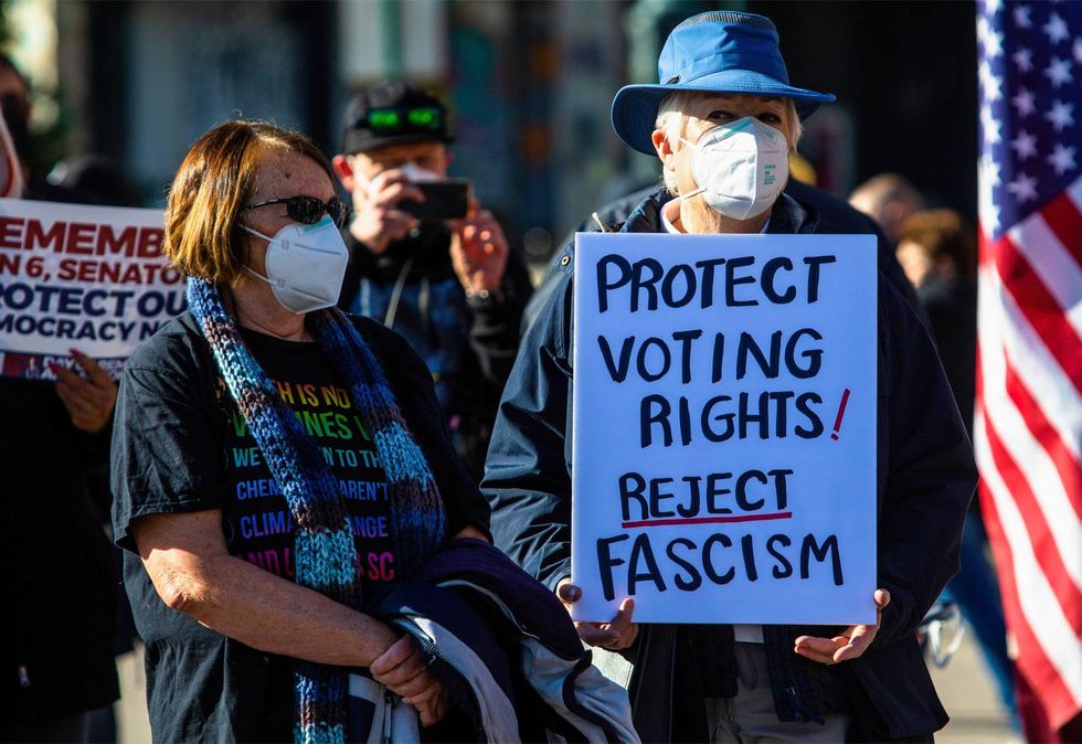Protesters and a sign reading