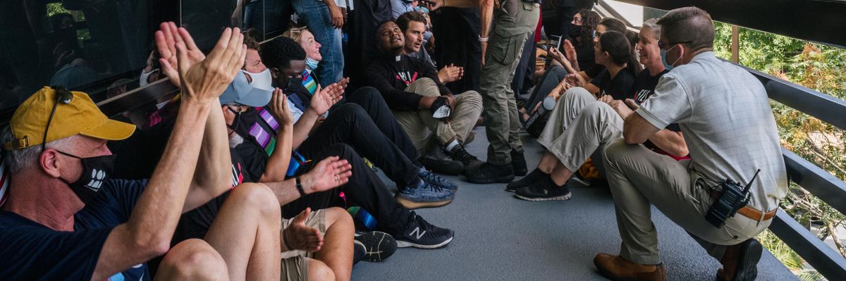 Protesters are processed by law enforcement during a sit-in demonstration outside the office of Sen. Kyrsten Sinema (D-Ariz.) on July 26, 2021 in Phoenix. (Photo: Brandon Bell via Getty Images)