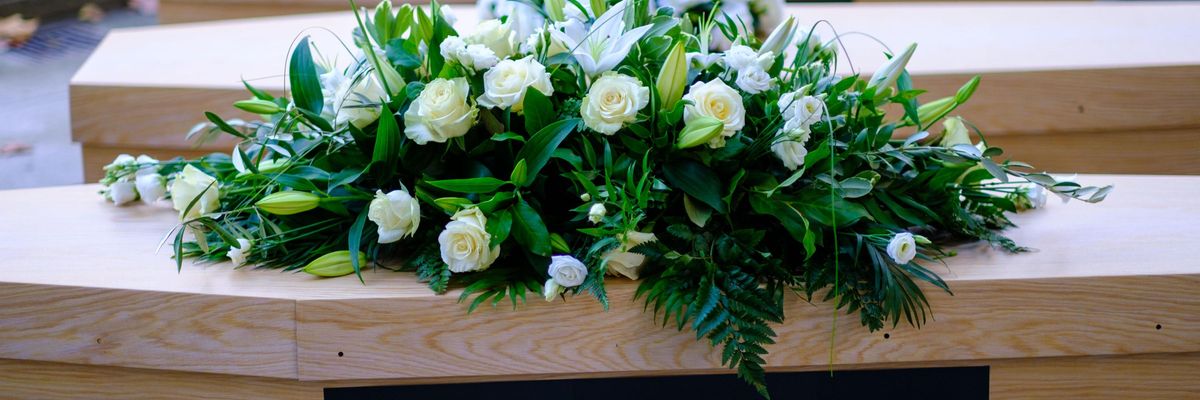 Protesters attached a "pharma greed kills" sign to a mock coffin