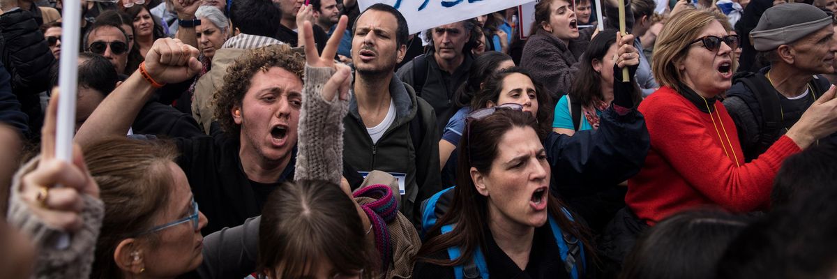 Protesters attend a massive demonstration in front of the Israeli parliament