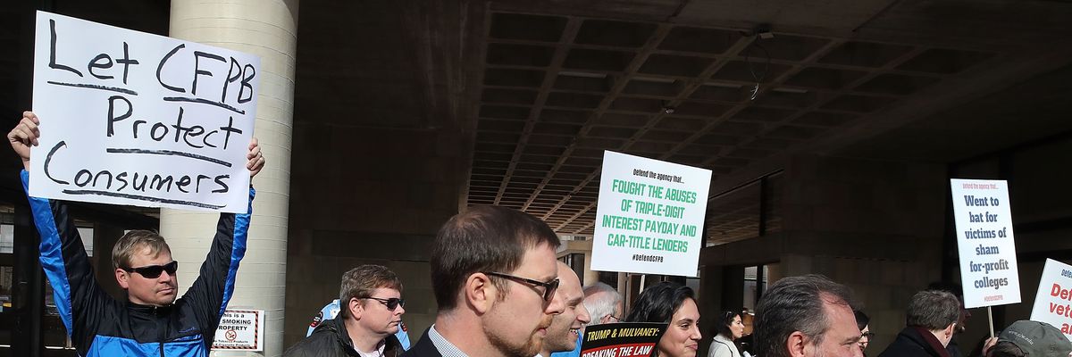 Protesters attend a rally in support of the CFPB