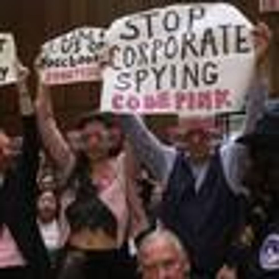 Protesters attend the hearing where Facebook co-founder and chief executive Mark Zuckerberg testified before a combined Senate Judiciary and Commerce committee hearing on April 10, 2018 in Washington, D.C. (Photo: Win McNamee/Getty Images)