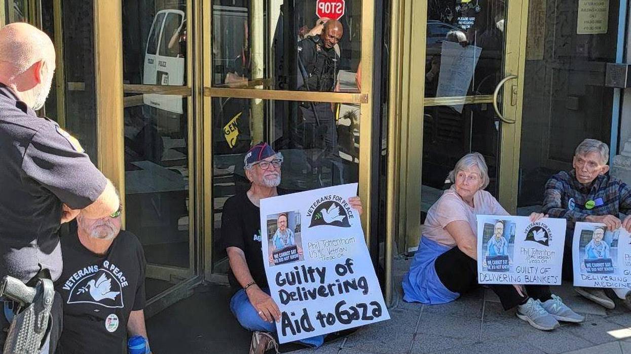 Protesters block the door to Sen. Husted's office for Gaza.