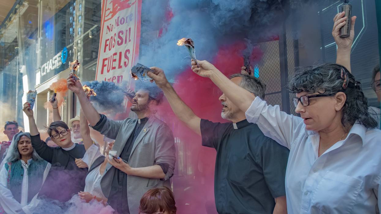 Protesters burn money outside JPMorgan Chase headquarters.