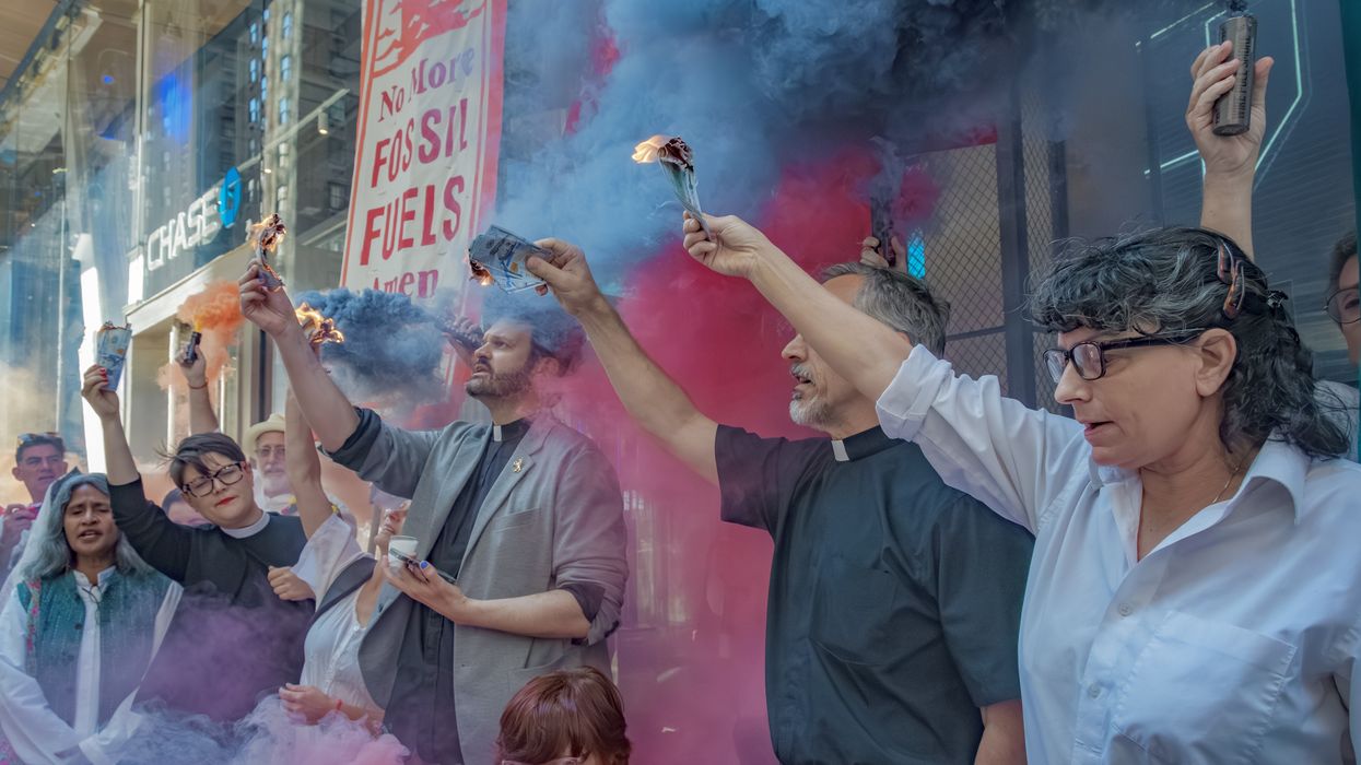 Protesters burn money outside JPMorgan Chase headquarters.
