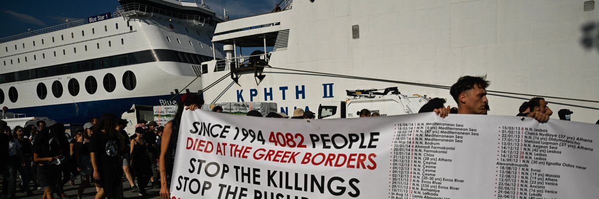Protesters carry a banner listing the cases of migrants' deaths