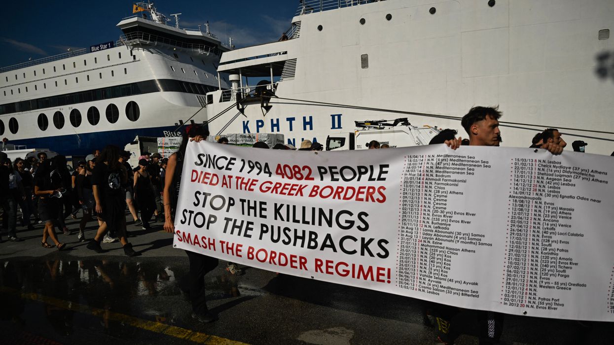 Protesters carry a banner listing the cases of migrants' deaths