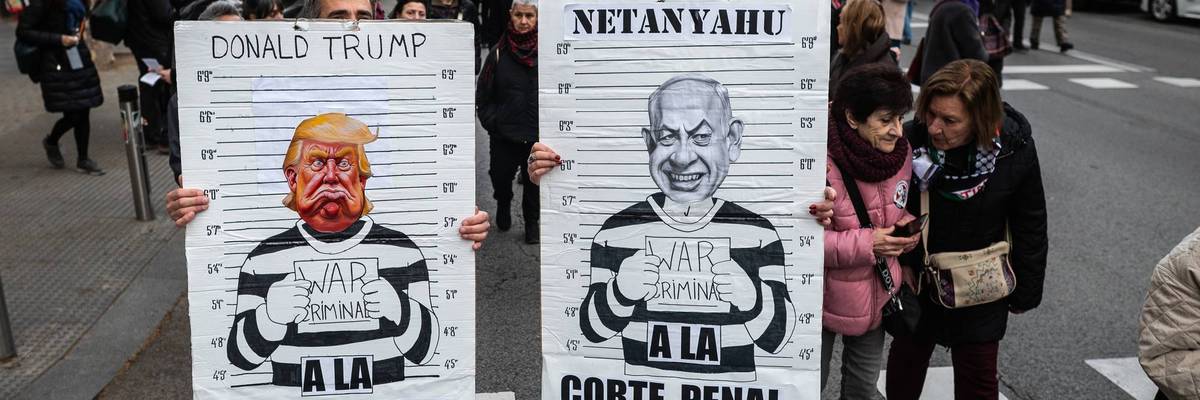 Protesters carry placards with the images of Donald Trump and Benjamin Netanyahu in jail.
