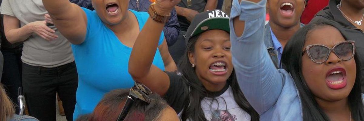 Protesters chant outside the Western District police station, after marchers stopped there following the death of local resident Freddie Gray while in police custody