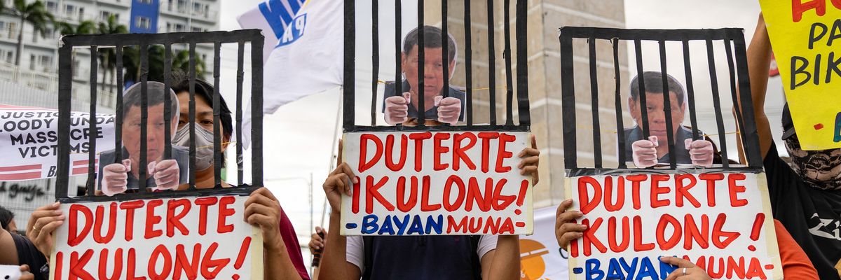 Protesters demonstrate demanding justice for drug war victims with signs