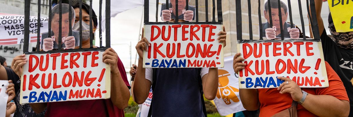 Protesters demonstrate demanding justice for drug war victims with signs