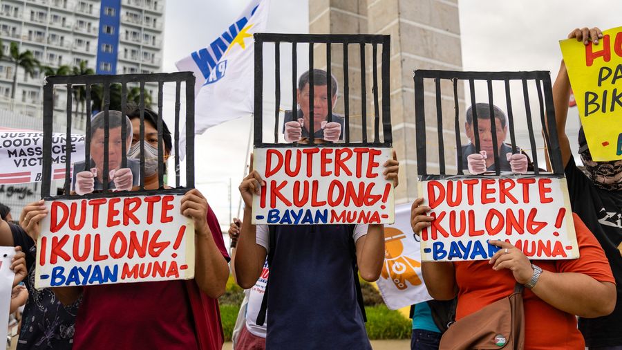 Protesters demonstrate demanding justice for drug war victims with signs