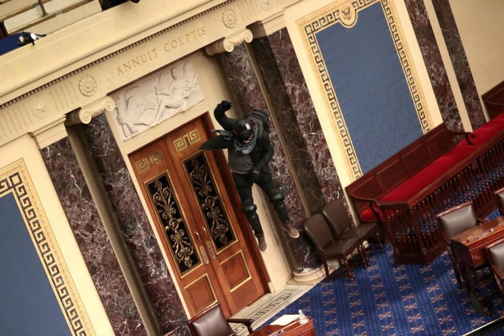 Protesters enter the Senate Chamber on January 06, 2021 in Washington, DC. Congress held a joint session today to ratify President-elect Joe Biden's 306-232 Electoral College win over President Donald Trump. Pro-Trump protesters have entered the U.S. Capitol building after mass demonstrations in the nation's capital. (Photo: Win McNamee/Getty Images)