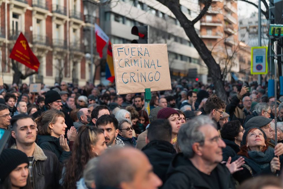 Protesters gather during a demonstration in front of the US Embassy in Madrid