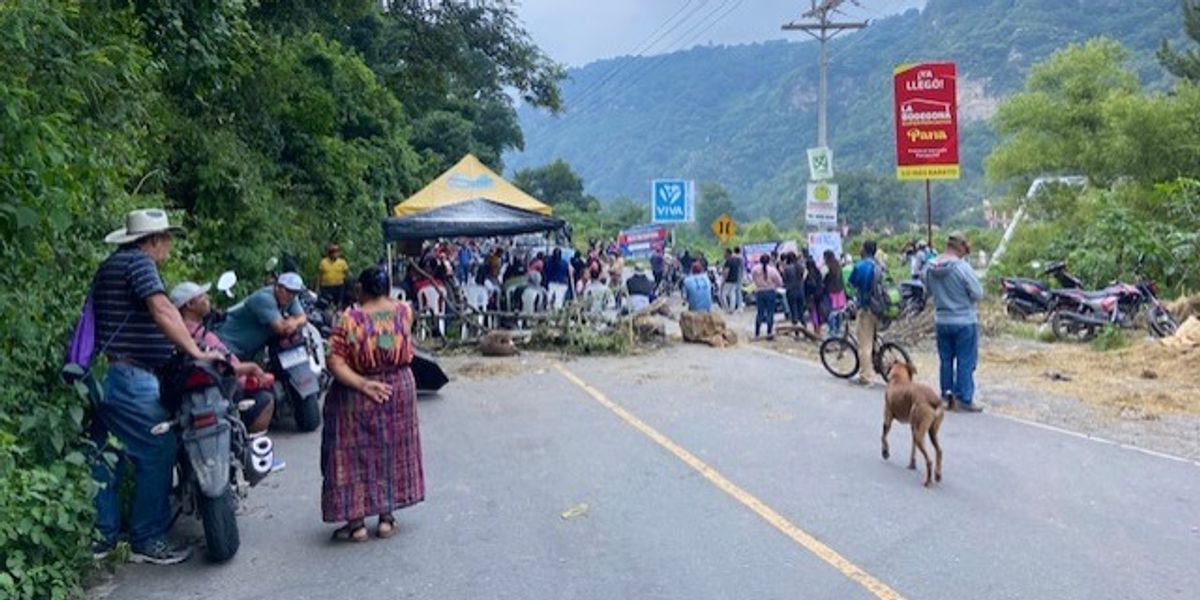 Protesters gather on a rural Guatemalan highway.