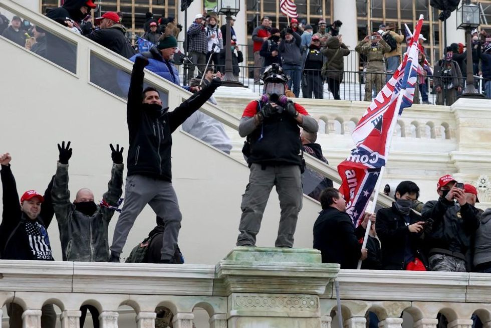 Protesters gather on the U.S. Capitol Building on January 06, 2021 in Washington, DC. Pro-Trump protesters entered the U.S. Capitol building after mass demonstrations in the nation's capital during a joint session Congress to ratify President-elect Joe Biden's 306-232 Electoral College win over President Donald Trump. (Photo: Tasos Katopodis/Getty Images)