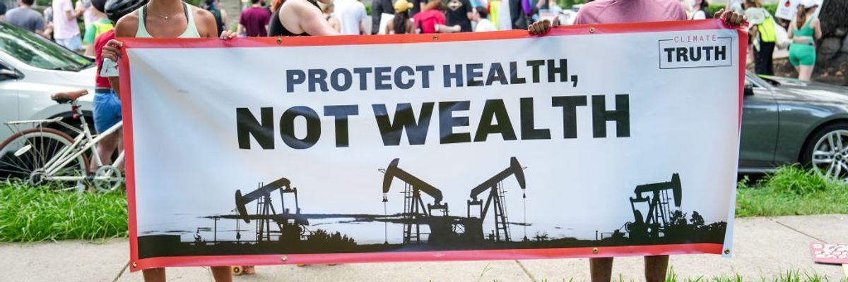 Protesters gather outside a Trump fundraiser