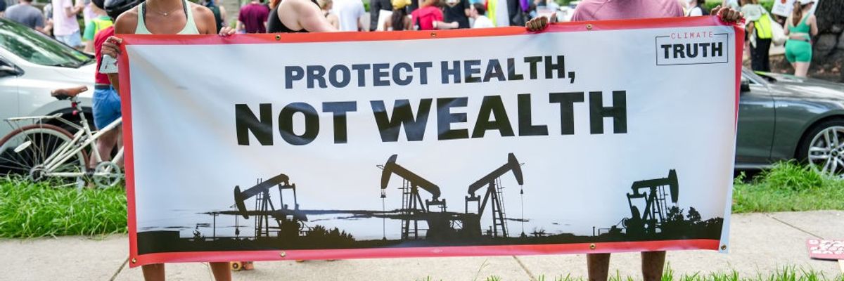Protesters gather outside the home of Boysie Bollinger during a fundraiser for then-Republican presidential candidate Donald Trump