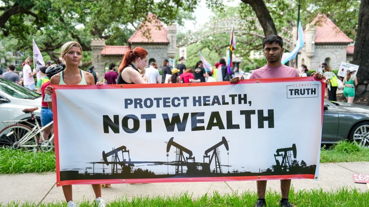 Protesters gather outside the home of Boysie Bollinger during a fundraiser for then-Republican presidential candidate Donald Trump