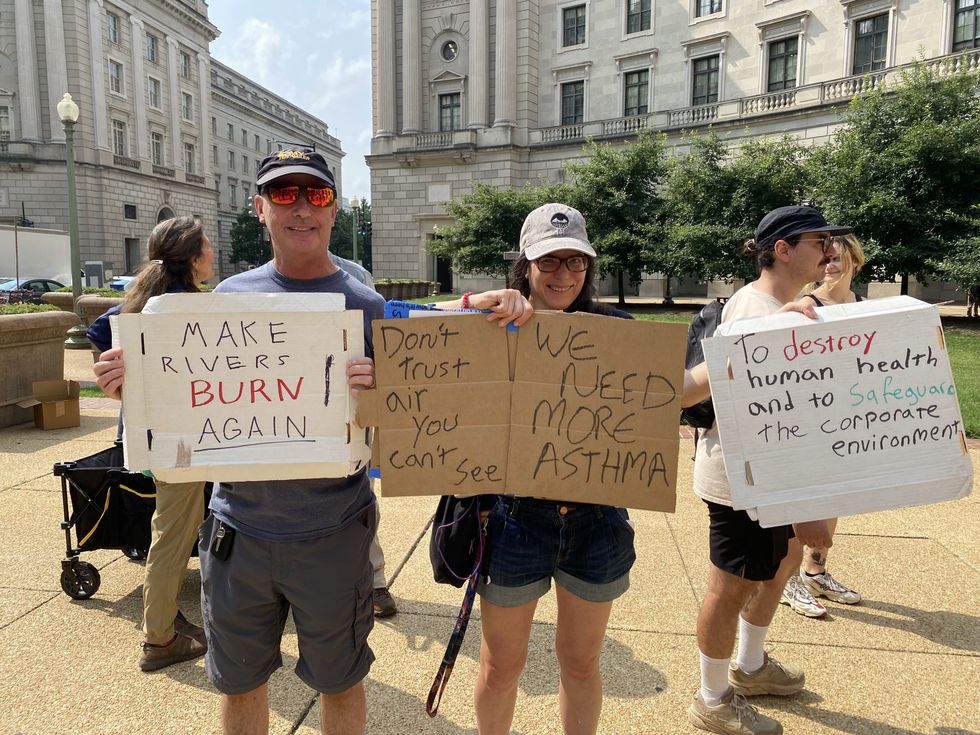 protesters held signs that called for making rivers burn, causing more asthma, and destroying human health