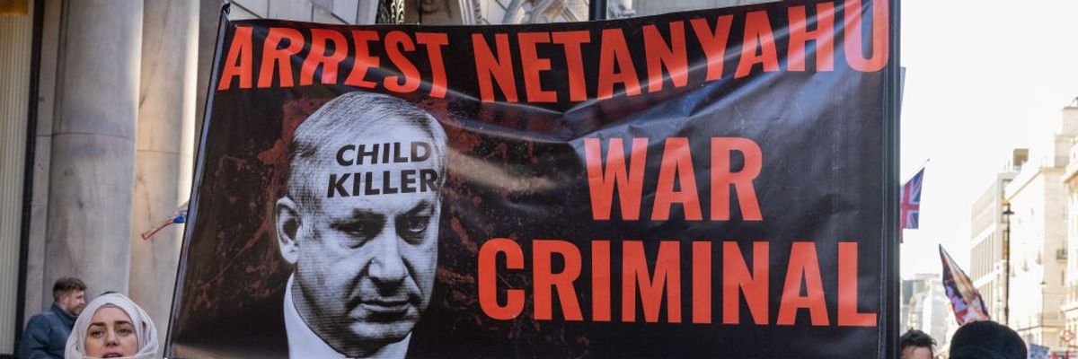 Protesters hold a banner reading "Arrest Netanyahu War Criminal" in London