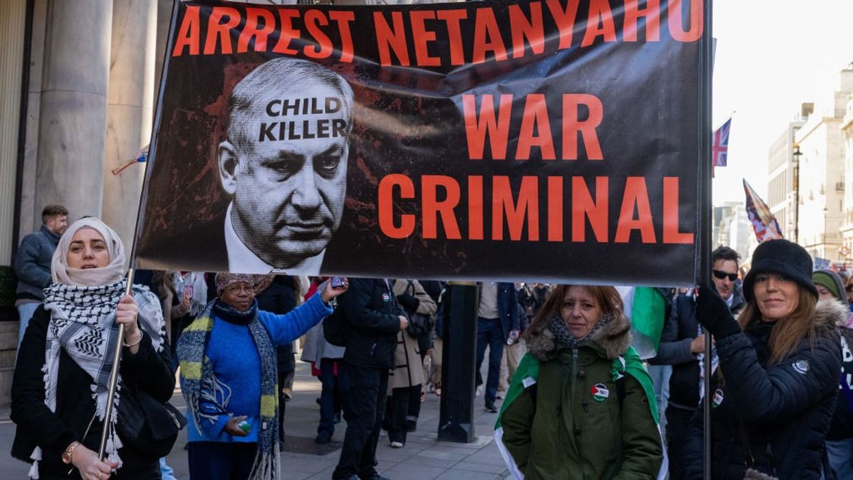 Protesters hold a banner reading "Arrest Netanyahu War Criminal" in London