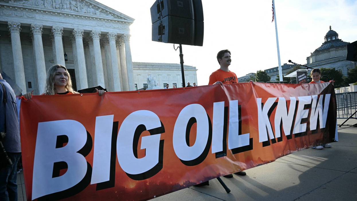 Protesters hold a banner reading "Big Oil Knew" outside the US Supreme Court