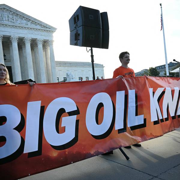 Protesters hold a banner reading "Big Oil Knew" outside the US Supreme Court